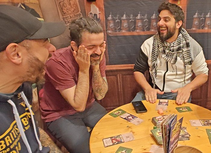 [VISUAL: Friends mid-game + full box visible]
